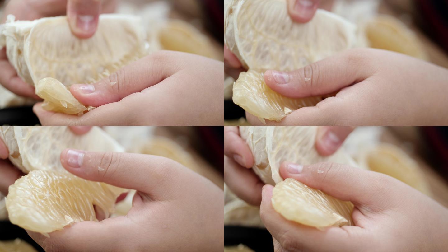男孩的手为家里的家人剥柚子，慢动作。