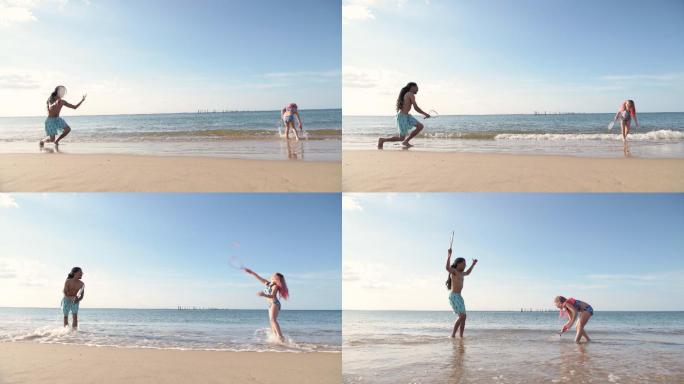 爸爸和女儿在海滩打羽毛球