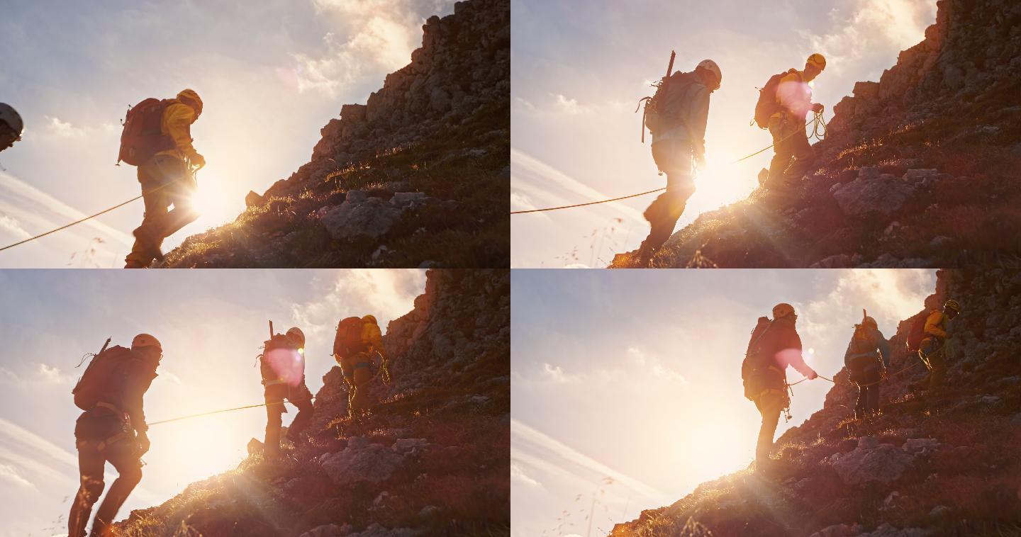 TD登山运动员在日落时缓慢走向山顶