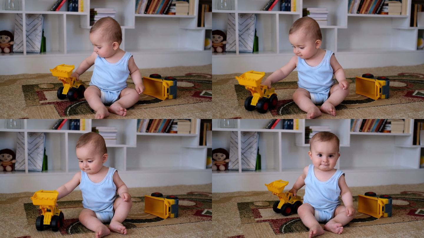 婴儿在房间里玩耍坐在地毯上的小孩儿工程车