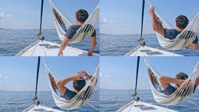 4K无忧无虑的人在阳光明媚的帆船上的吊床上放松，实时