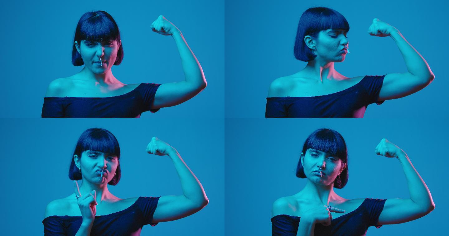 年轻女性柔韧的二头肌独立于蓝色霓虹灯的广告空间