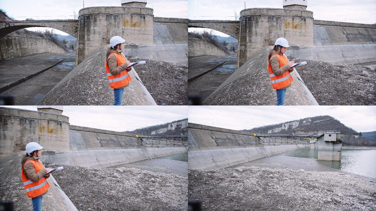 在水电站大坝工作的女工程师。生态导向。可再生能源系统。