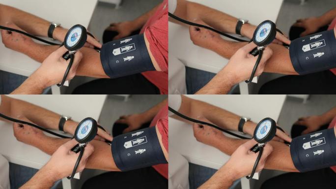 医生测量男性患者血压