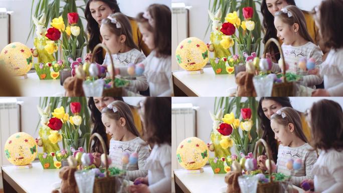 复活节快乐！一位母亲和她的小女儿给复活节彩蛋着色。股票视频