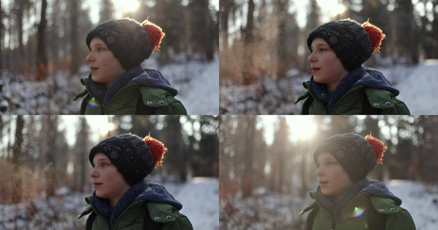 小男孩在美丽的冬季森林中徒步旅行的肖像。