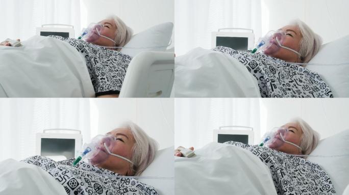 病房：美丽的老妇人戴着氧气面罩躺在床上，病后完全康复。老太太梦想着她的家人、朋友、幸福的生活。