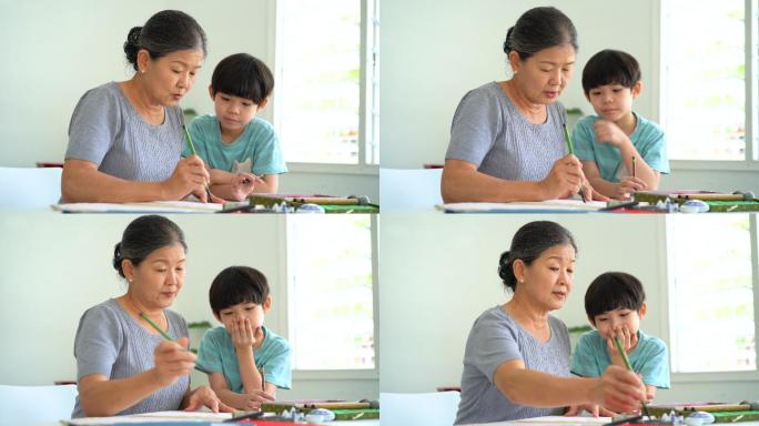 亚洲资深女子在家教孙子中国传统书法