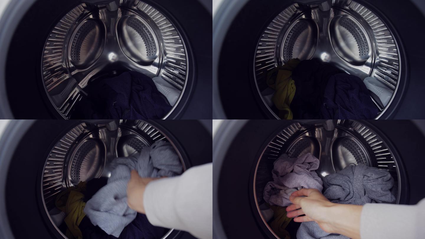 双手将衣物放入洗衣机滚筒