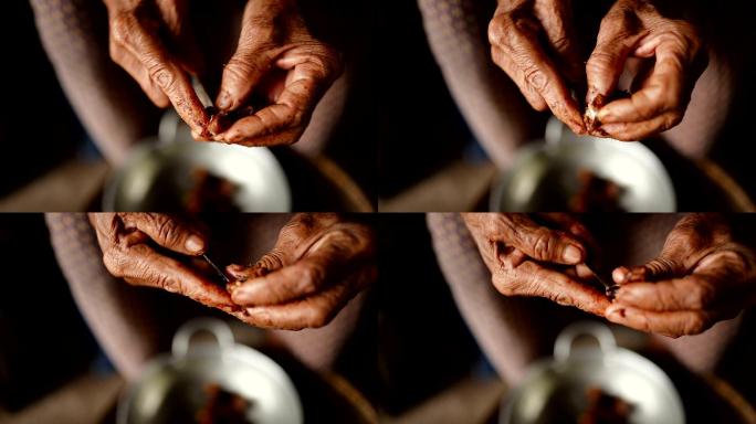 老年女性手准备Paan或槟榔或槟榔混合物的特写镜头。