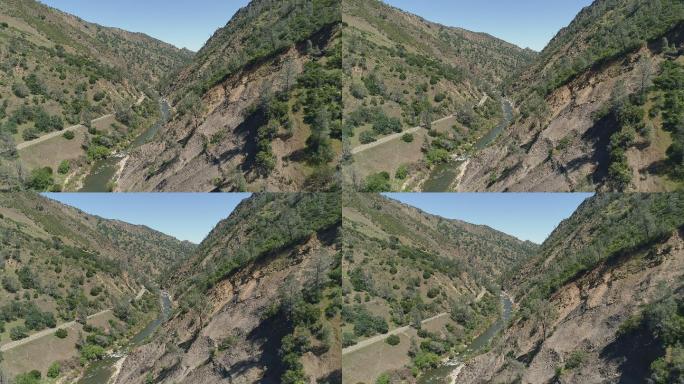 加州拉姆西附近卡什溪峡谷被泥石流摧毁的侵蚀山坡鸟瞰图。具有前向摄像头运动的无人机视频。