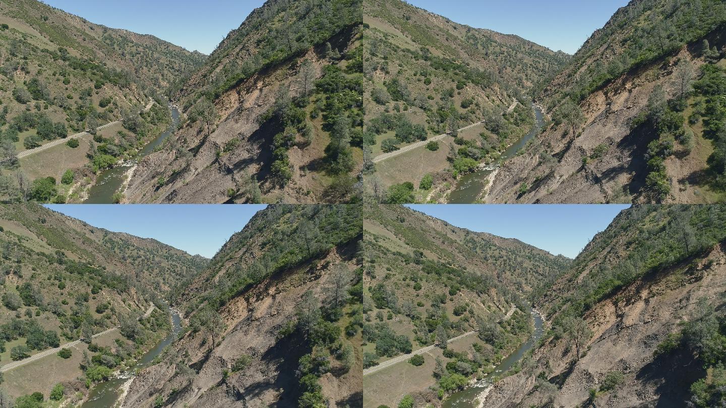 加州拉姆西附近卡什溪峡谷被泥石流摧毁的侵蚀山坡鸟瞰图。具有前向摄像头运动的无人机视频。