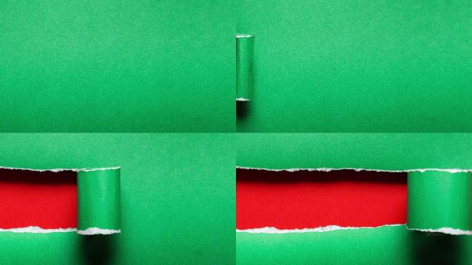 4k：纸的停止运动被绿色背景撕裂，圣诞节概念