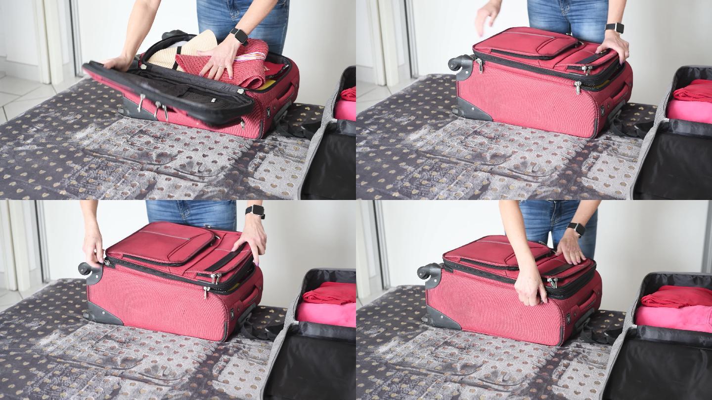 为旅行打包。女性为新的旅行将衣服装进手提箱的特写镜头