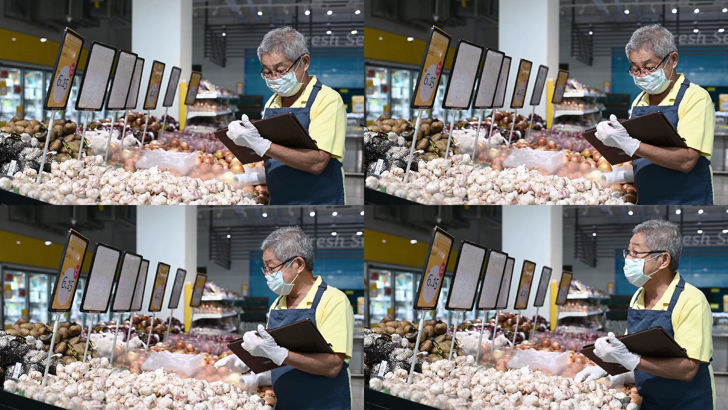 一位亚裔中国资深男子超市店主戴着口罩的零售助理