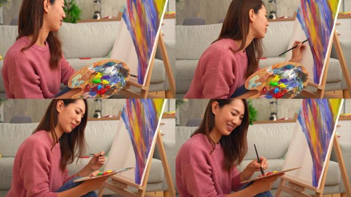 年轻女画家在家绘画