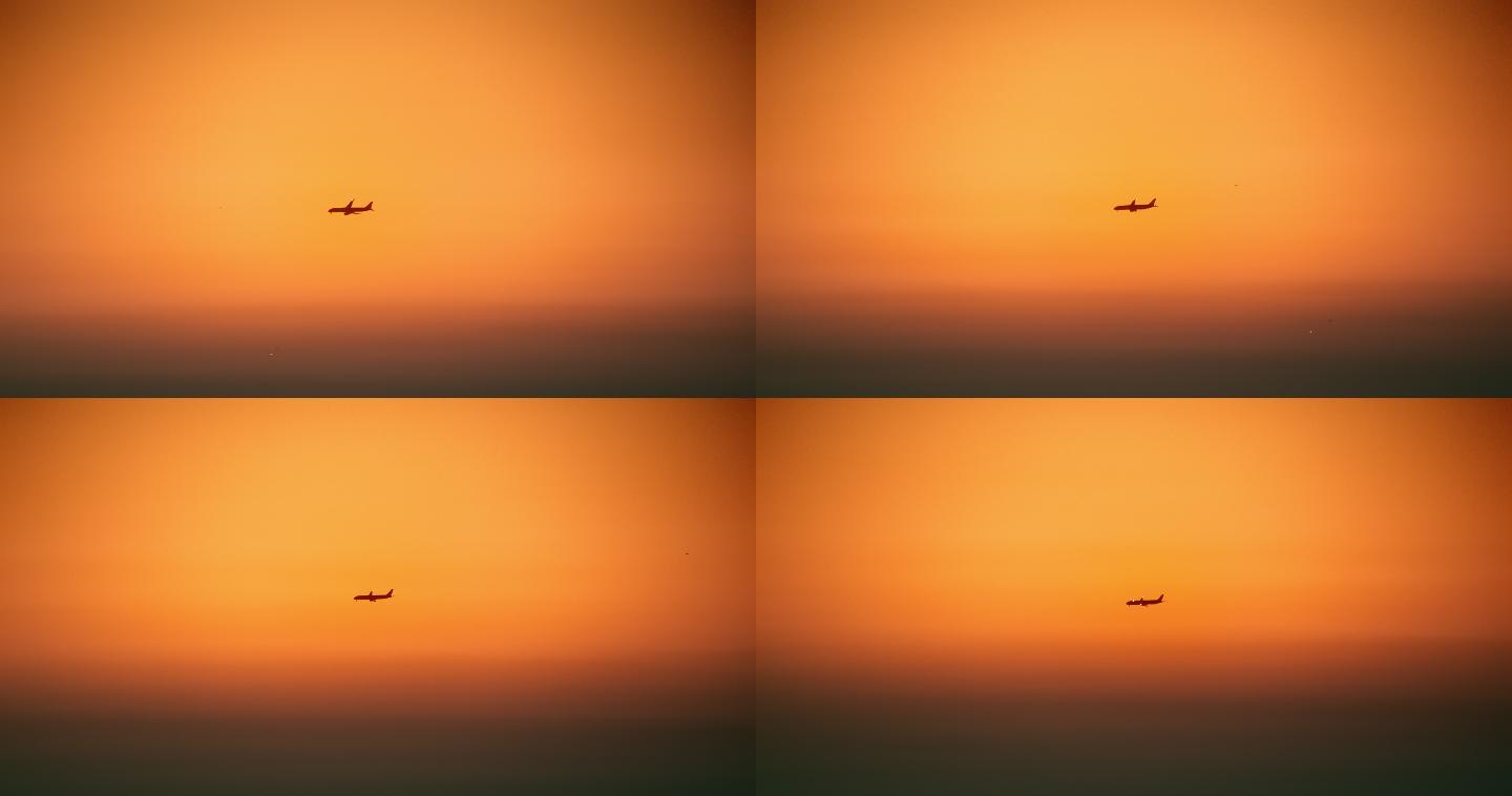 黄昏时分在橙色天空中飞过的飞机
