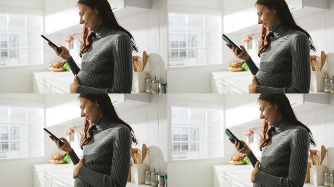 孕妇使用手机触摸孕肚玩手机休闲娱乐