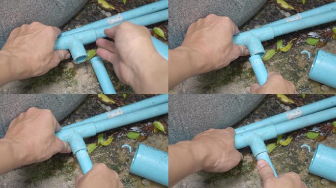 手动连接蓝色PVC管的特写