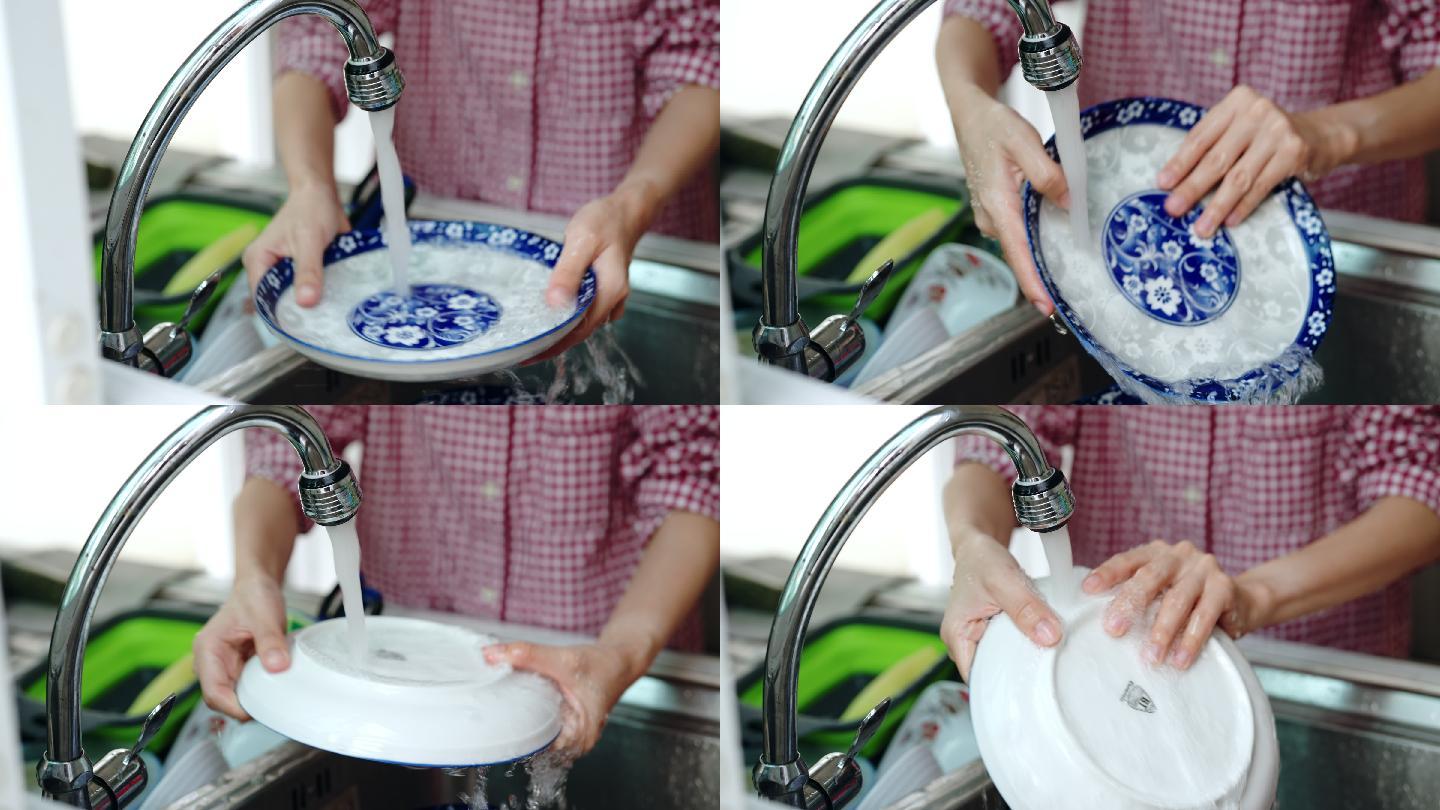 在家洗碗的女人。洗盘子
