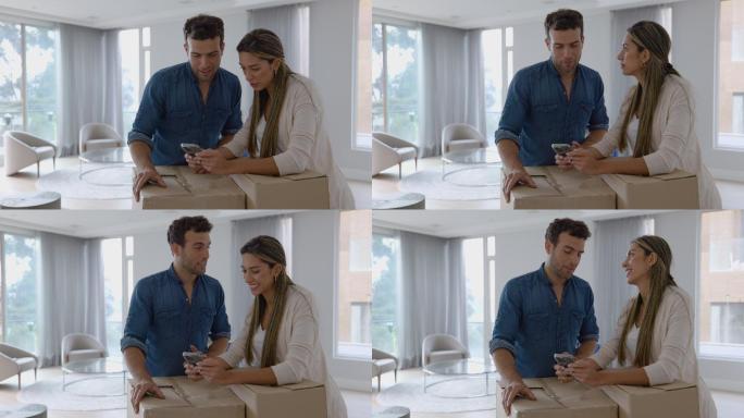 一对拉丁美洲夫妇在搬进新家时使用手机上的应用程序，两人看起来都很开心