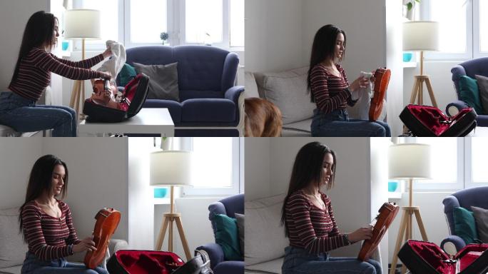 这位年轻女子打开小提琴包，擦拭琴弦，准备练习拉小提琴。