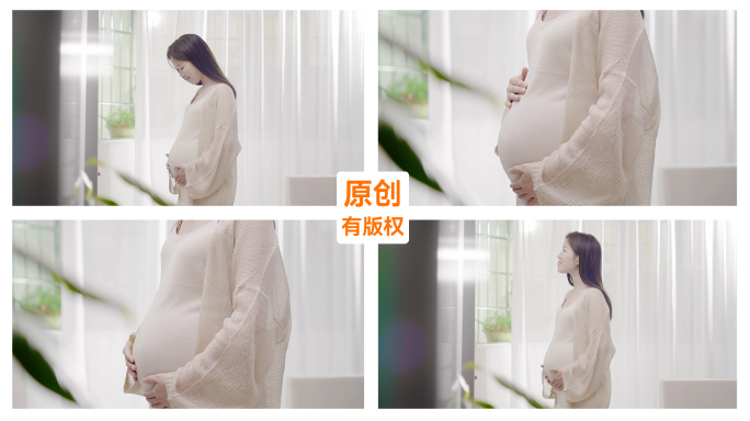 孕妇站在窗前抚摸肚子