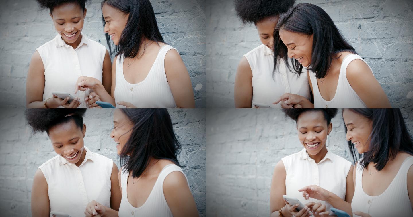 两名年轻女性倚着灰墙使用智能手机的4k视频片段