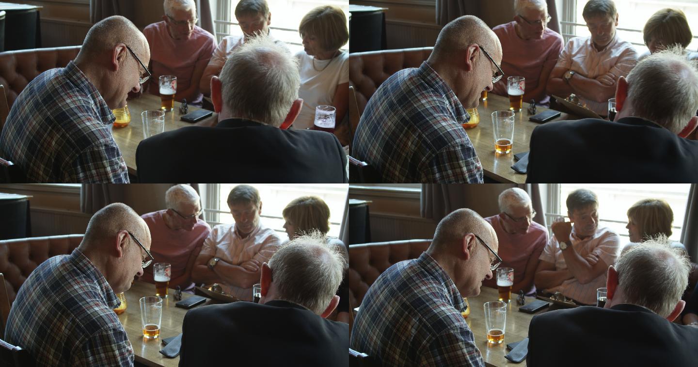 退休的朋友们聚在酒吧里喝酒吃饭，看菜单
