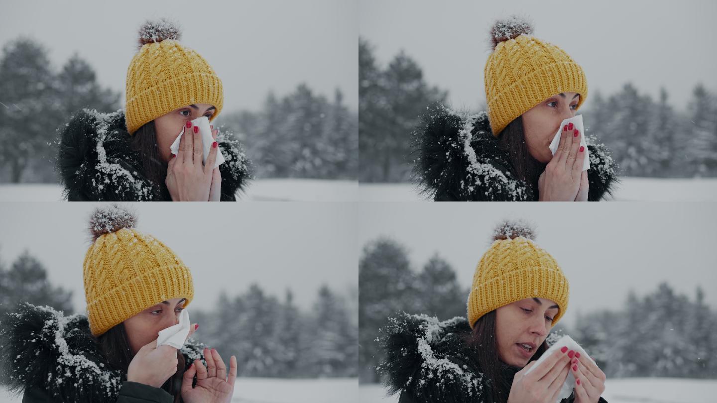 女人在擤鼻涕下雪天