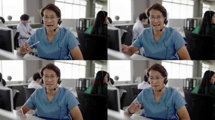 一位亚洲医生在呼叫中心的办公室里看着摄像机和视频通话，查看药物和补充剂的使用情况。