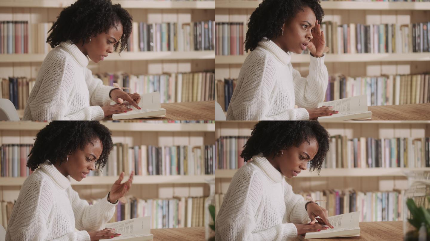 一位非洲裔女性在客厅里读着迷人的书。情节扭曲的情绪反应。