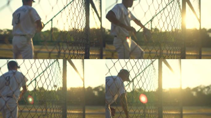 棒球运动员在日落时练习