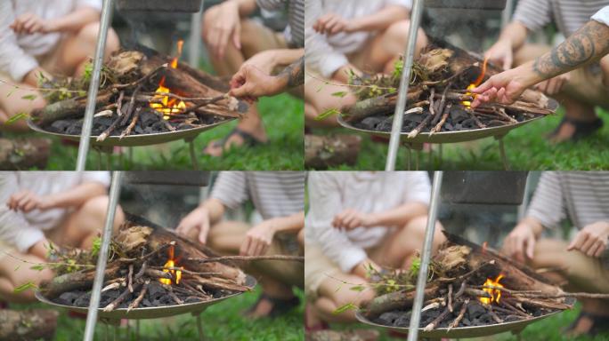 野营的亚裔中国人用柴火和大锅煮炖汤晚餐