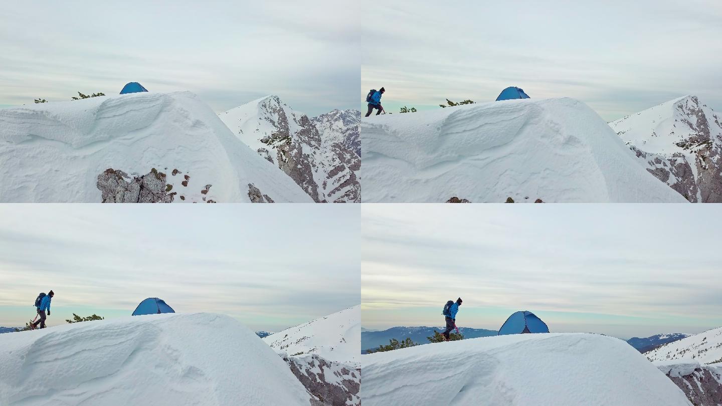 拿着冰斧的人登上雪山庆祝成功