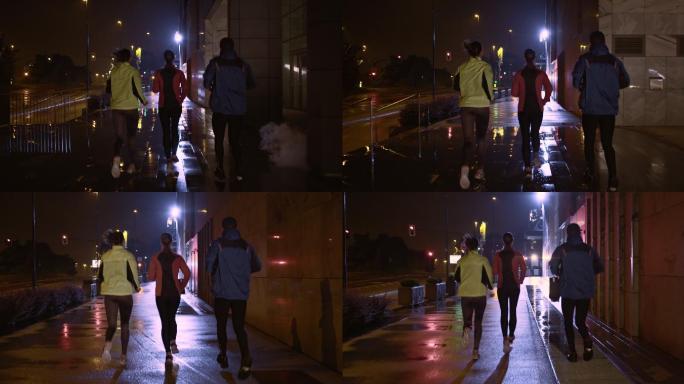 朋友们在雨夜在城里跑步