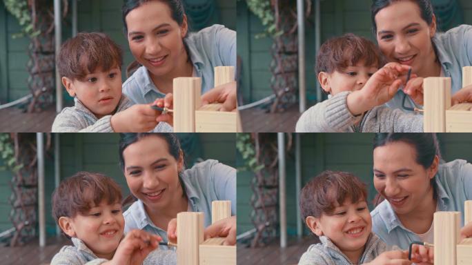 一名年轻女子和她可爱的儿子在家里做一个木制项目的4k视频片段