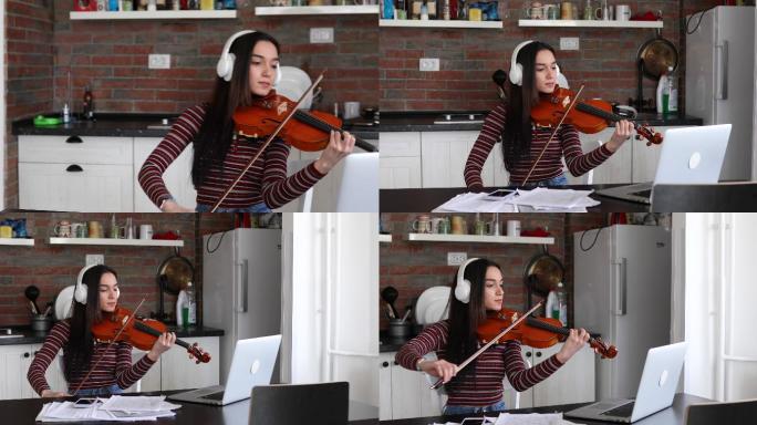 重点音乐学校的女生在在线小提琴课上练习拉小提琴。