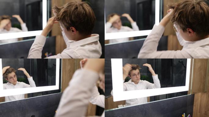 一个十几岁的男孩早上在深蓝色的浴室里做发型。