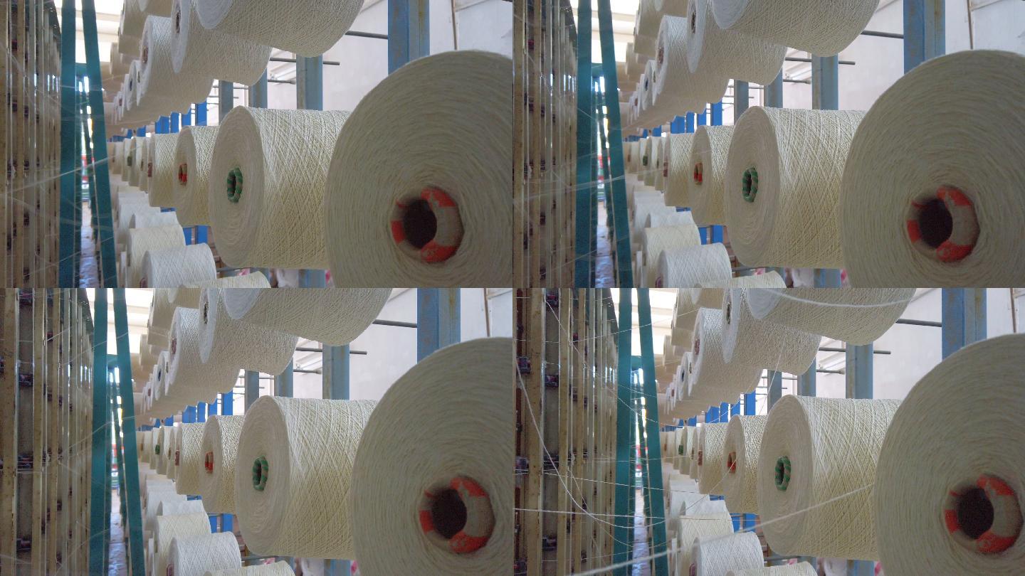 纺织厂工业整经针织束线机上的白纱卷轴筒管线锥按顺序排列