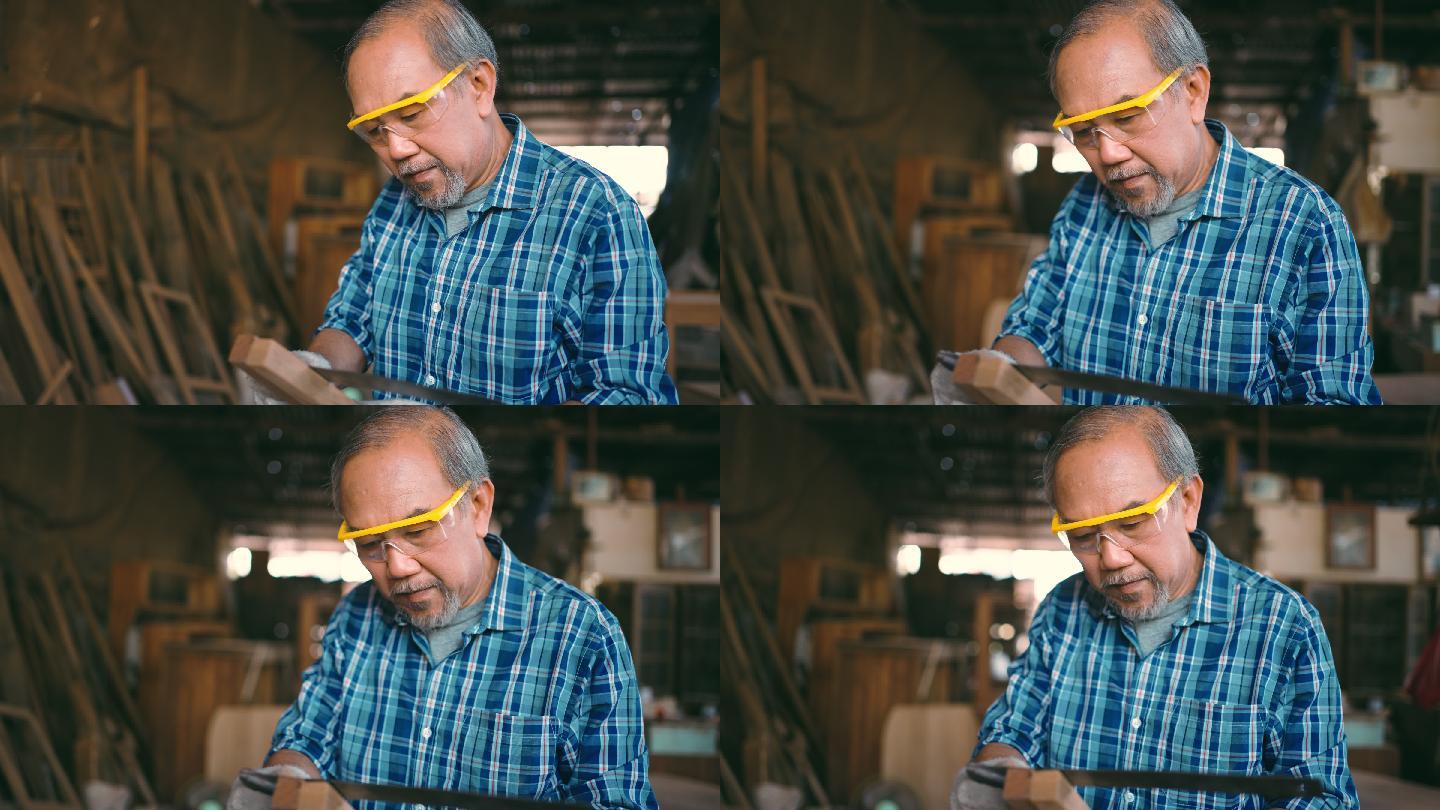 活跃的老年木匠在闲暇时间与木材一起工作。