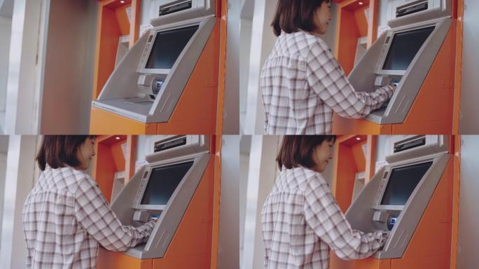 使用ATM的女性取款取钱自助取款机