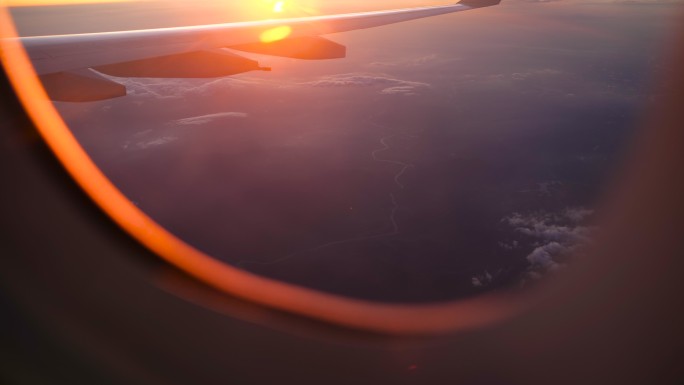 透过飞机的窗户，观看壮观的河流、蘑菇云和日落
