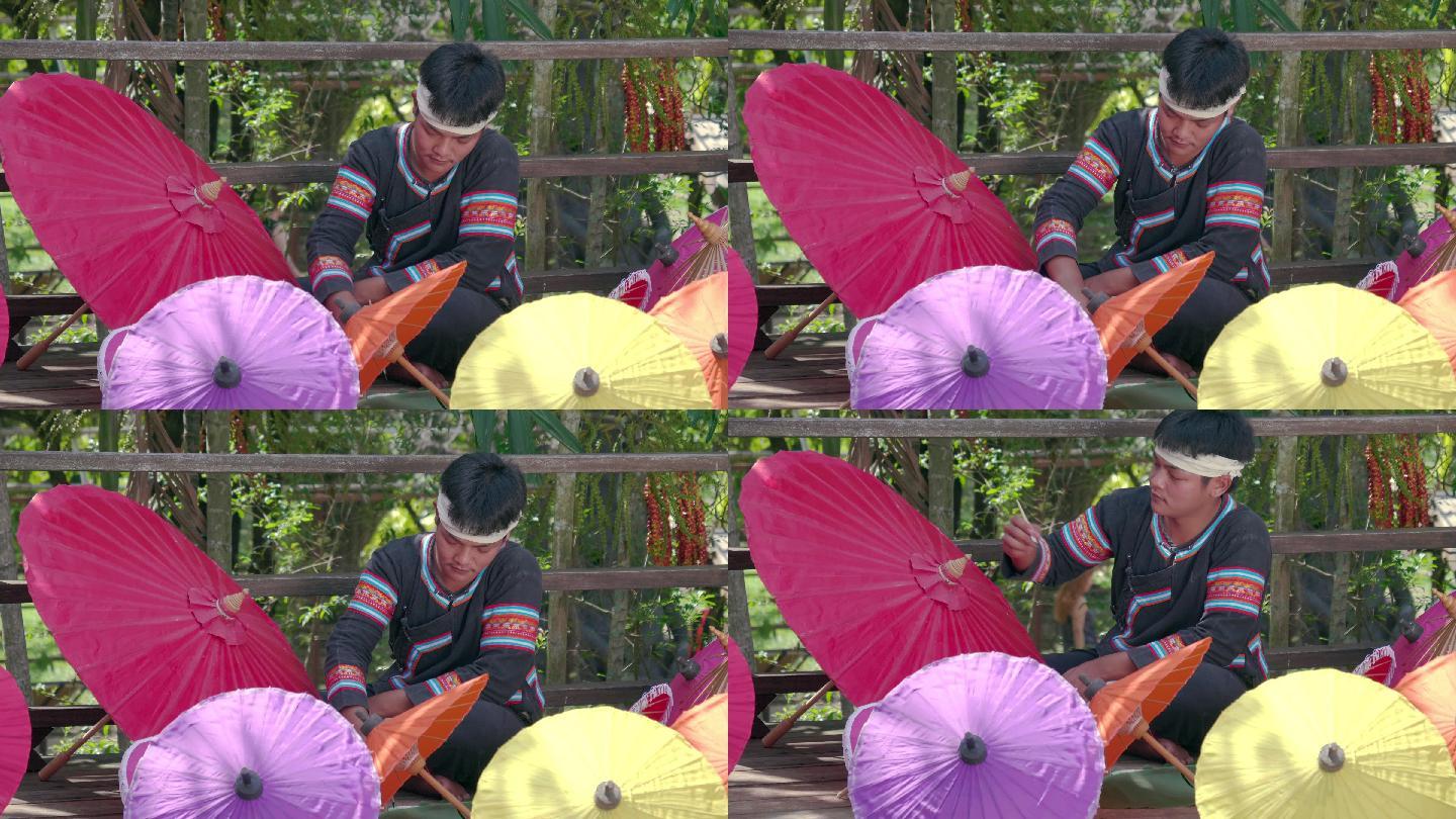 亚洲年轻人手工制作雨伞