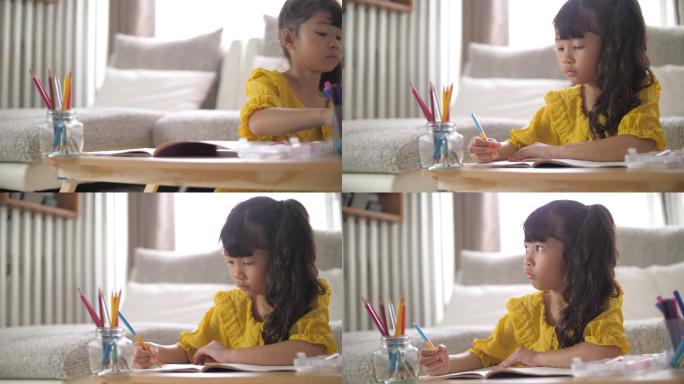 小女孩在家客厅画画和做作业