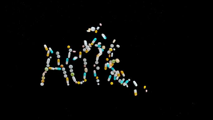 SLO MO LD“孤独症”铭文由从黑色表面飞出的彩色药片、药丸和胶囊制成
