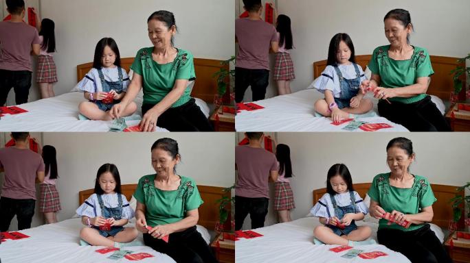 一位亚洲祖母和她的孙女一起为中国除夕准备红包