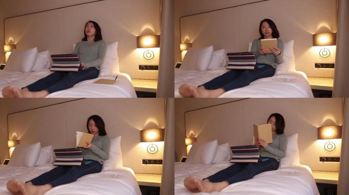在酒店房间工作的年轻女子开始看书
