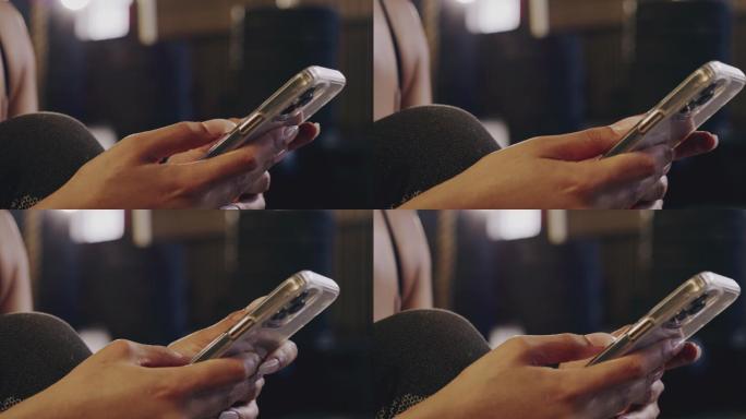 4k剪辑的视频片段，一个无法辨认的年轻女子在健身房使用手机