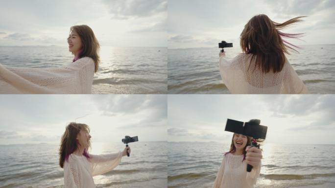 旅游影响者用相机为她的追随者拍摄海景。